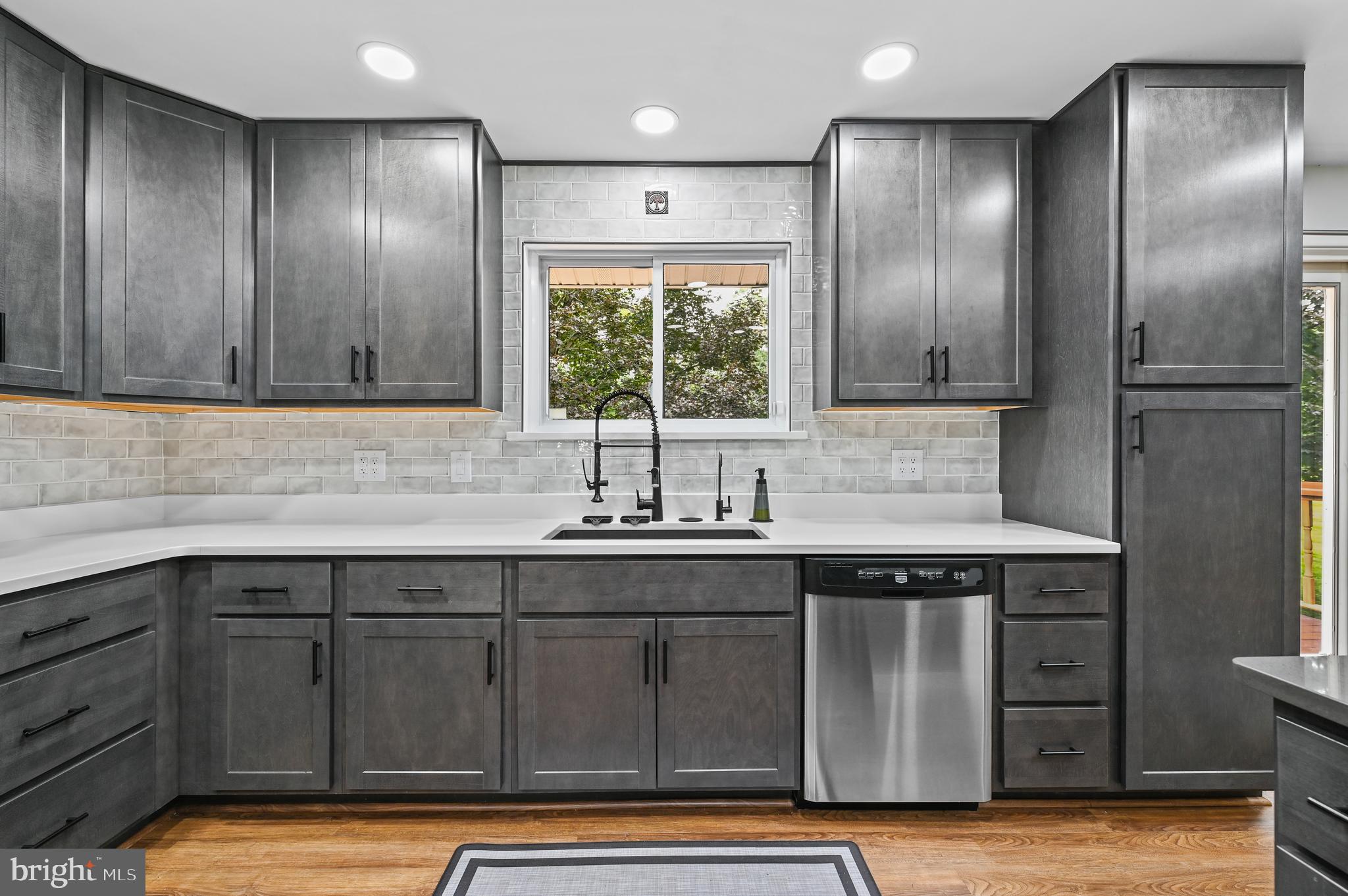 313 Faust Road Reading, PA 19608 - Photo 13 of 32 a kitchen with stainless steel appliances granite countertop a sink and a large window