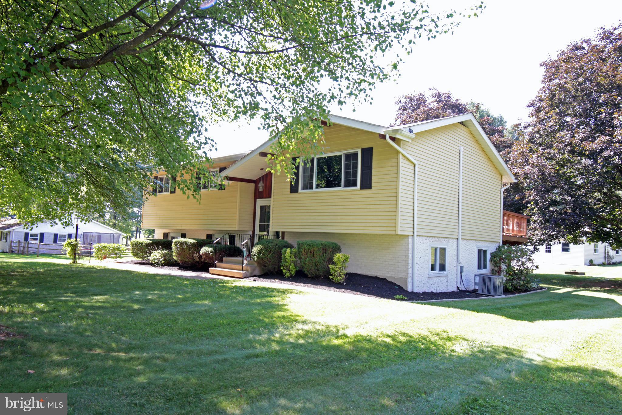 313 Faust Road Reading, PA 19608 - Photo 5 of 32 a front view of house with yard and trees in the background