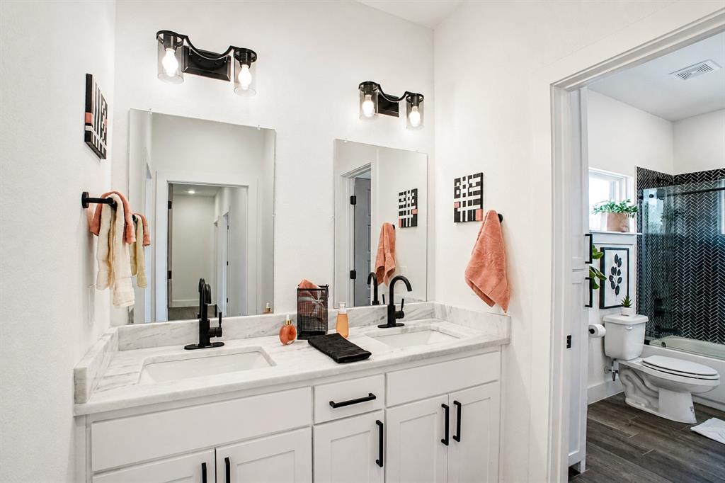 311 Dobbs Trail Springtown, TX 76082 - Photo 31 of 33 a bathroom with a sink vanity toilet and shower