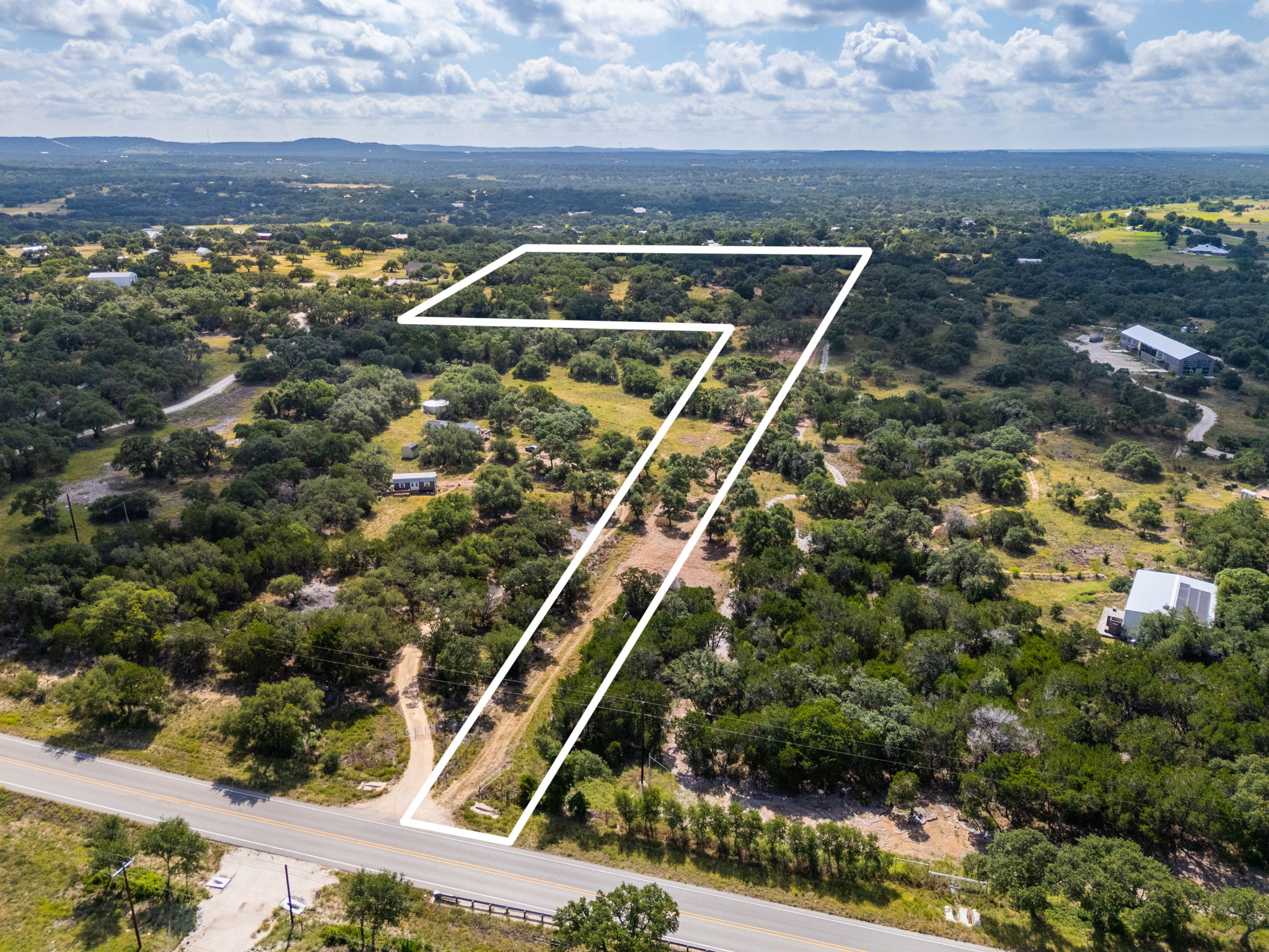 5385 Ranch Road 165 Blanco, TX 78606 - Photo 3 of 40 A vast, tree-dotted landscape with a clear boundary line, offering a scenic and private setting.