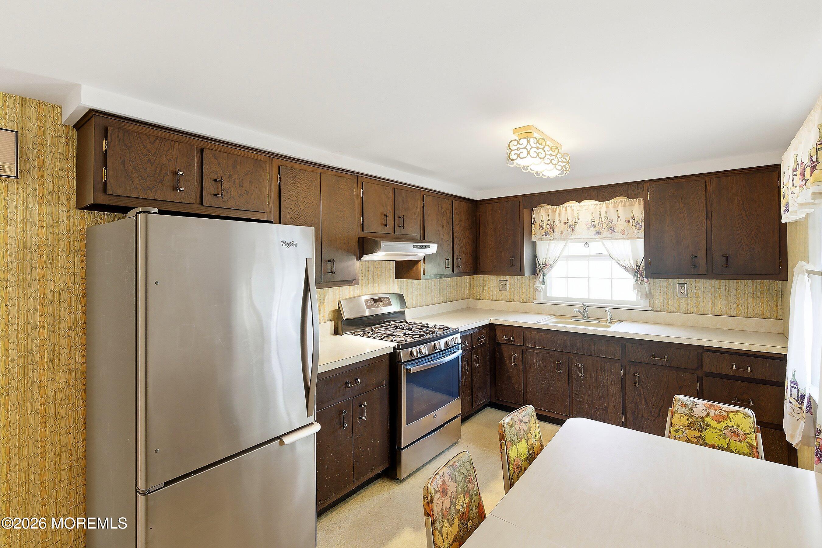 464 Newport Road Forked River, NJ 08731 - Photo 10 of 23 a kitchen with stainless steel appliances granite countertop a refrigerator a stove a sink dishwasher and white cabinets with wooden floor