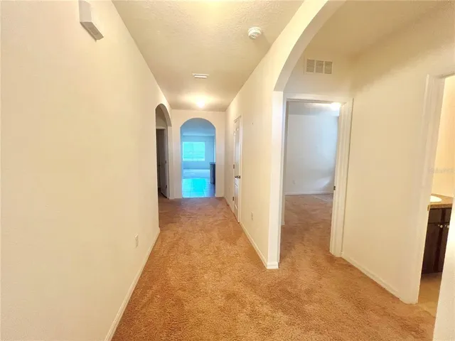 a view of hallway with wooden floor