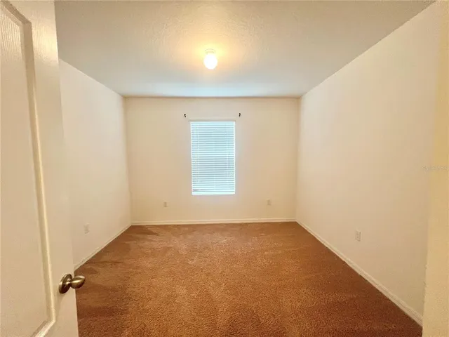 an empty room with a empty space and a window