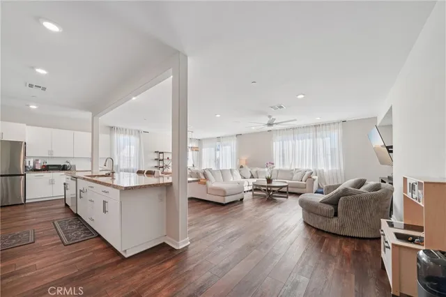 a view of a a dining room with furniture window and wooden floor