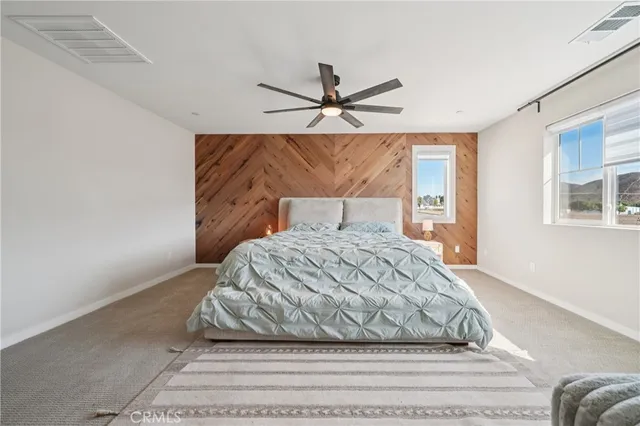 a bedroom with bed and a chandelier
