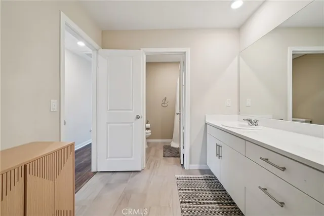 a living room with furniture and a dining table with kitchen view