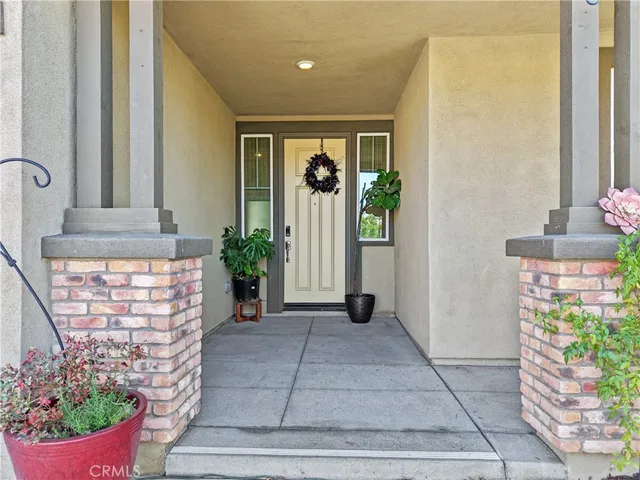 a front view of a house with potted plants