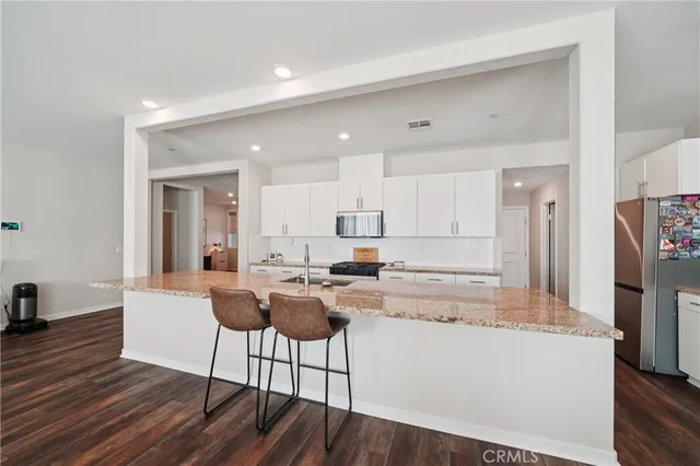 a living room with furniture and kitchen view