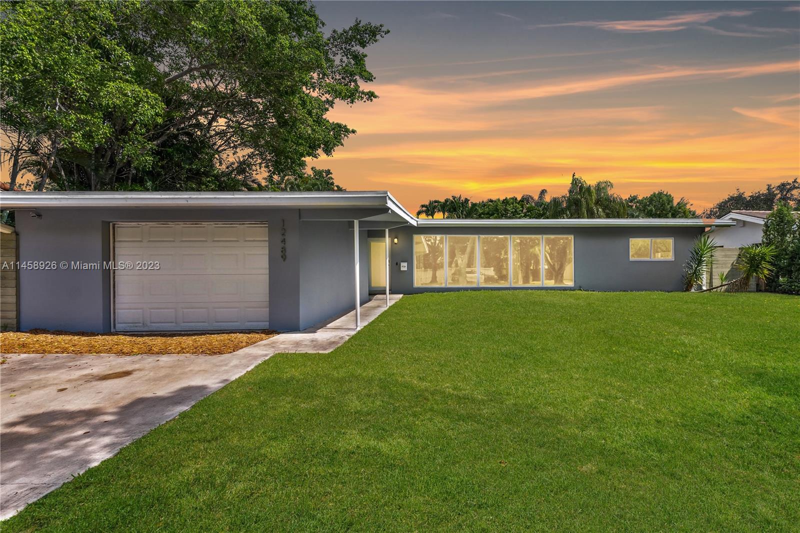 12489 Keystone Road North Miami, FL 33181 - Photo 1 of 1 a front view of house with yard and green space