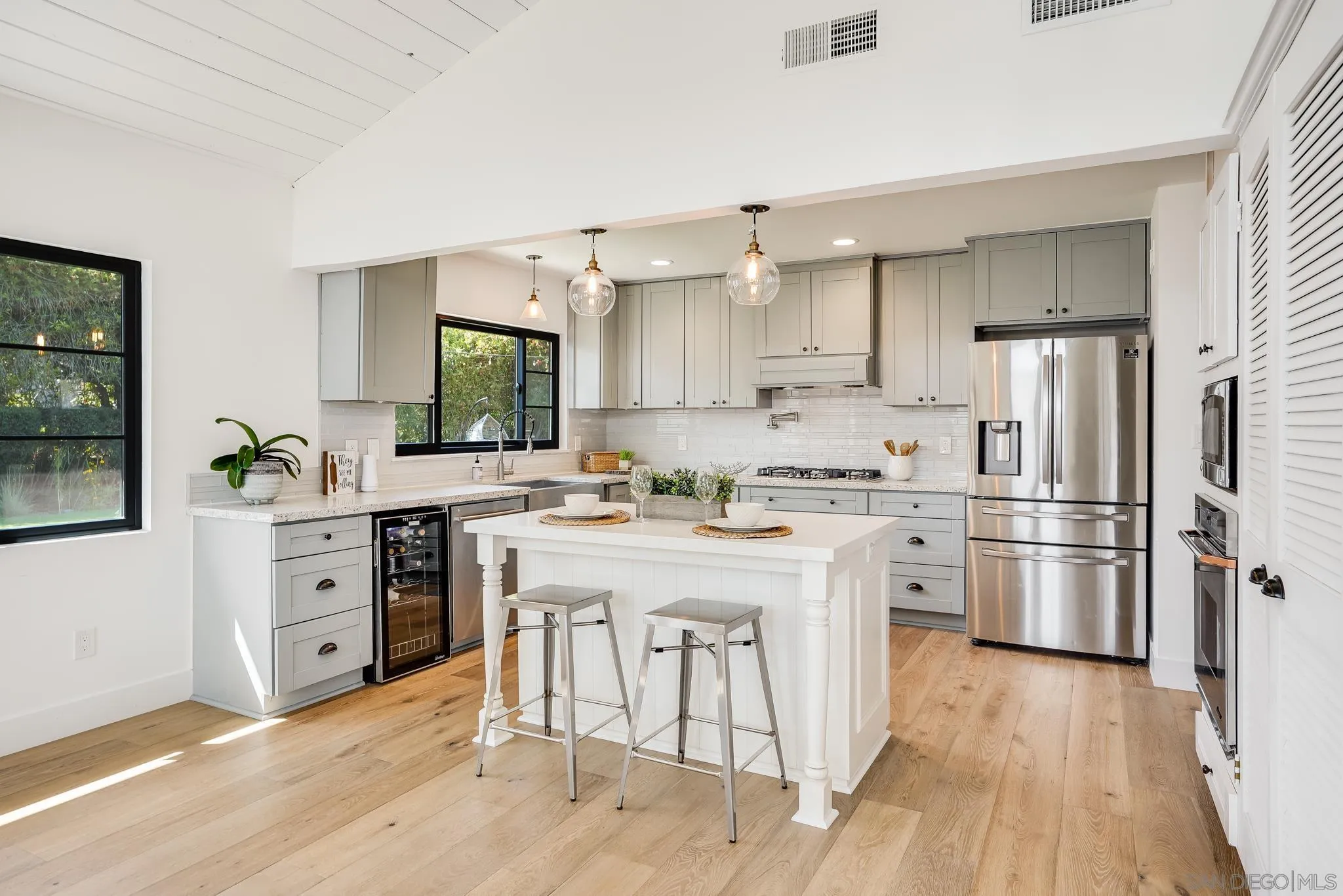 8804 Robinhood Lane La Jolla, CA 92037 - Photo 16 of 58 a kitchen with white cabinets and stainless steel appliances