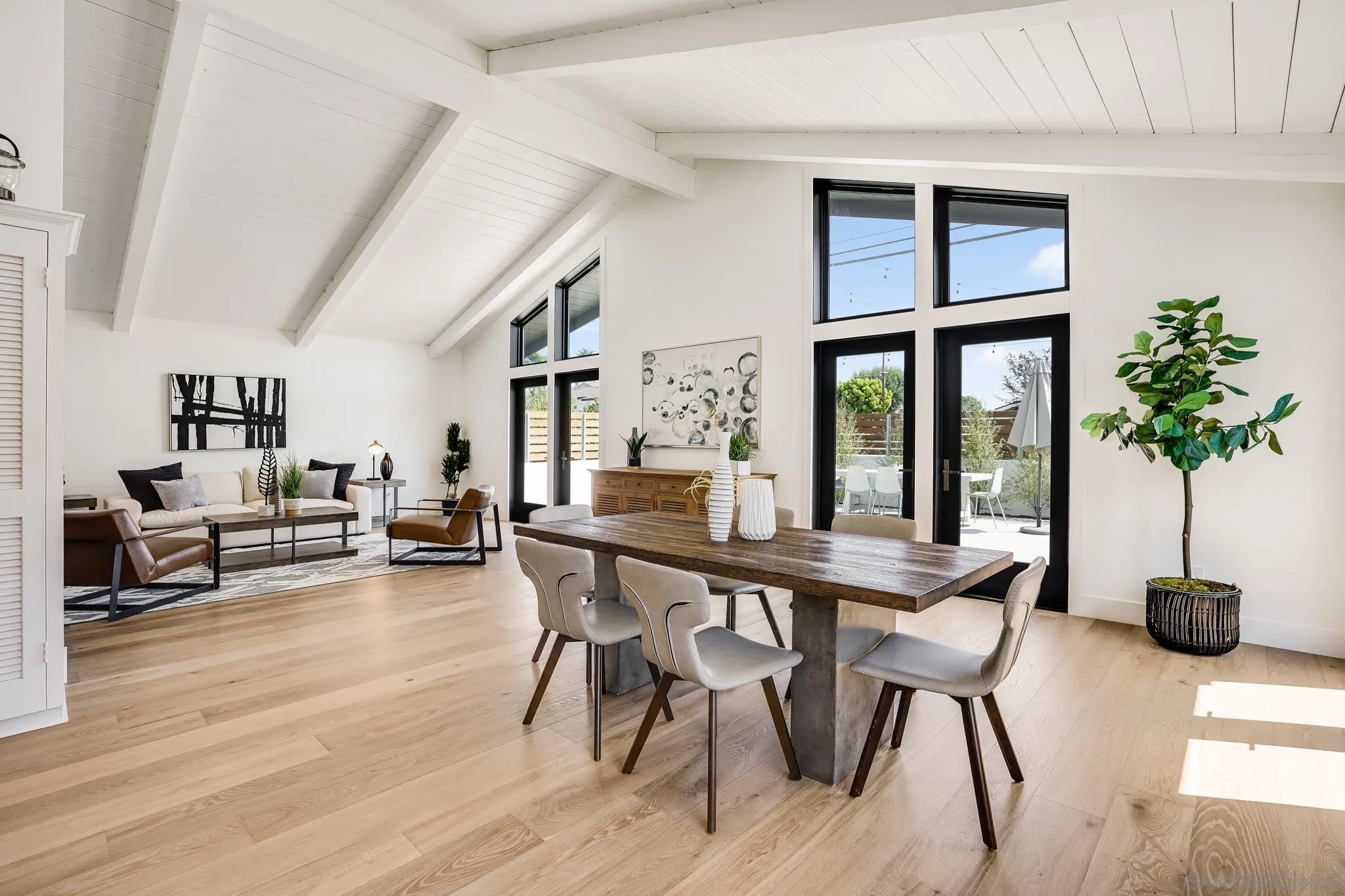8804 Robinhood Lane La Jolla, CA 92037 - Photo 17 of 58 a dining room with furniture potted plants and wooden floor