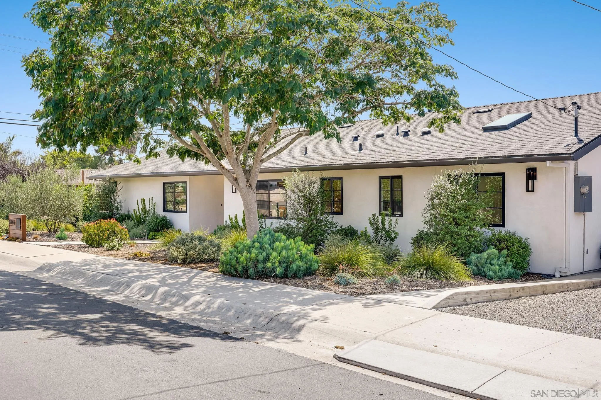 8804 Robinhood Lane La Jolla, CA 92037 - Photo 2 of 58 a front view of a house with a garden
