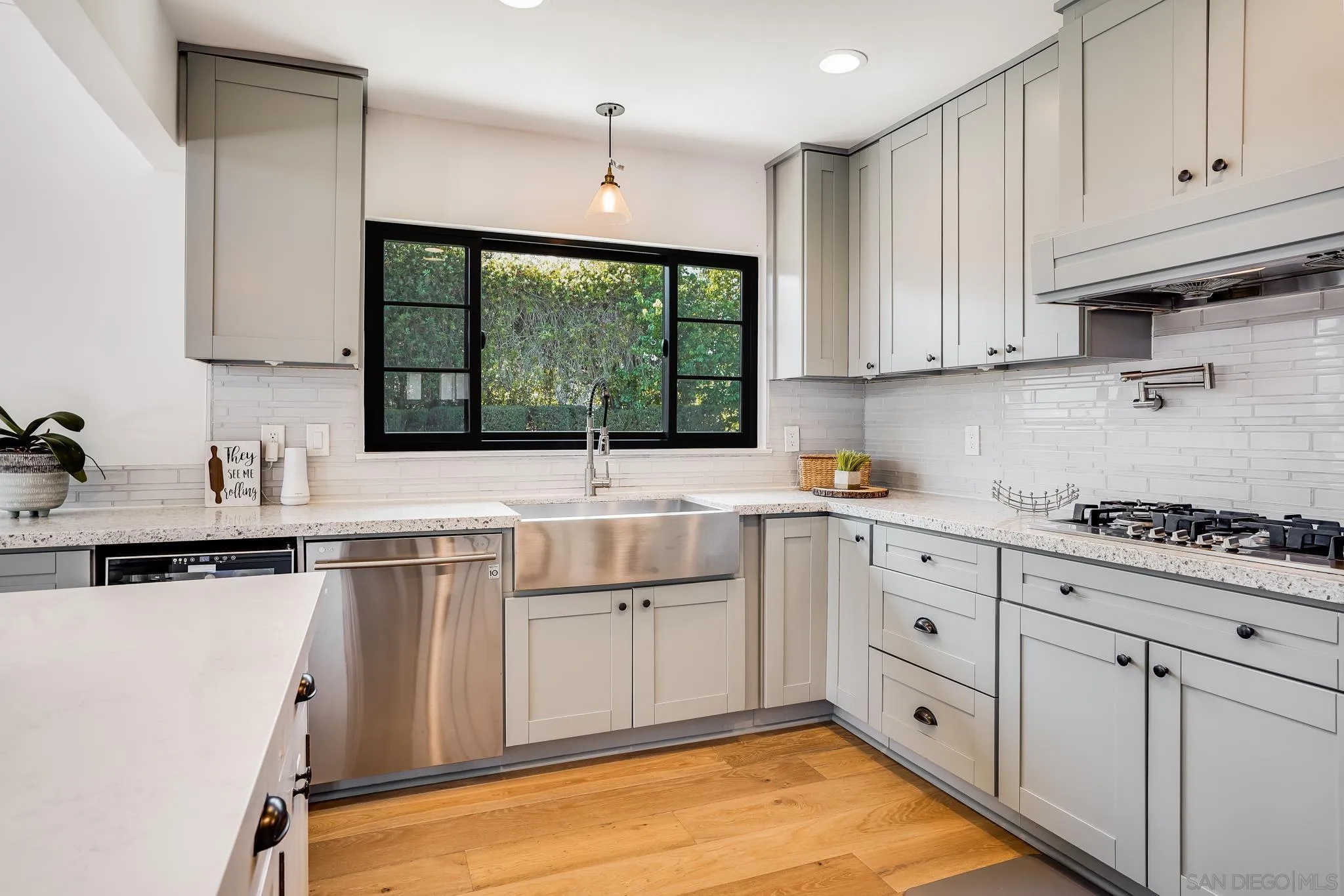 8804 Robinhood Lane La Jolla, CA 92037 - Photo 21 of 58 a kitchen with a sink window and cabinets