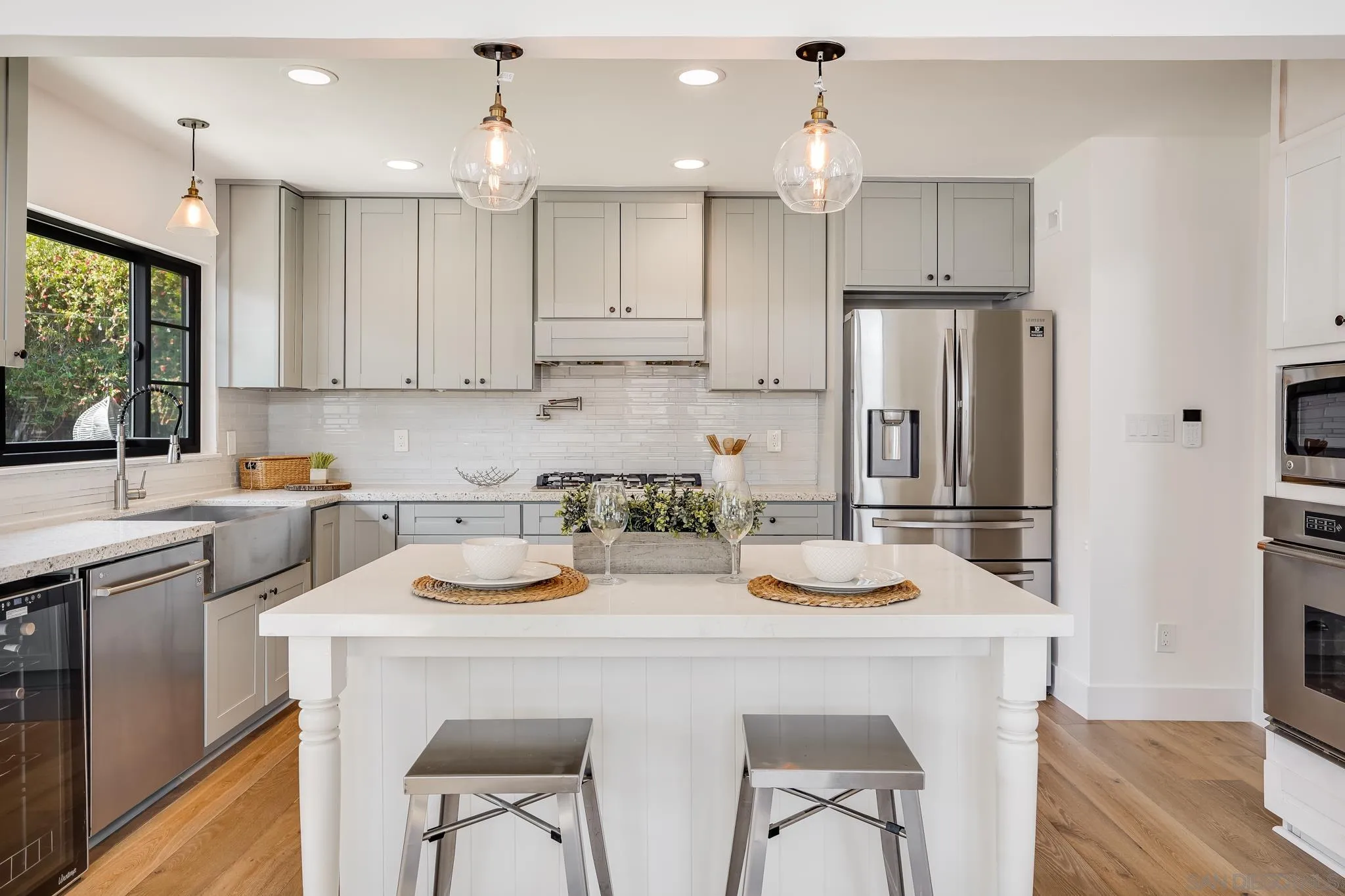 8804 Robinhood Lane La Jolla, CA 92037 - Photo 22 of 58 a kitchen with kitchen island a stove a table and chairs in it