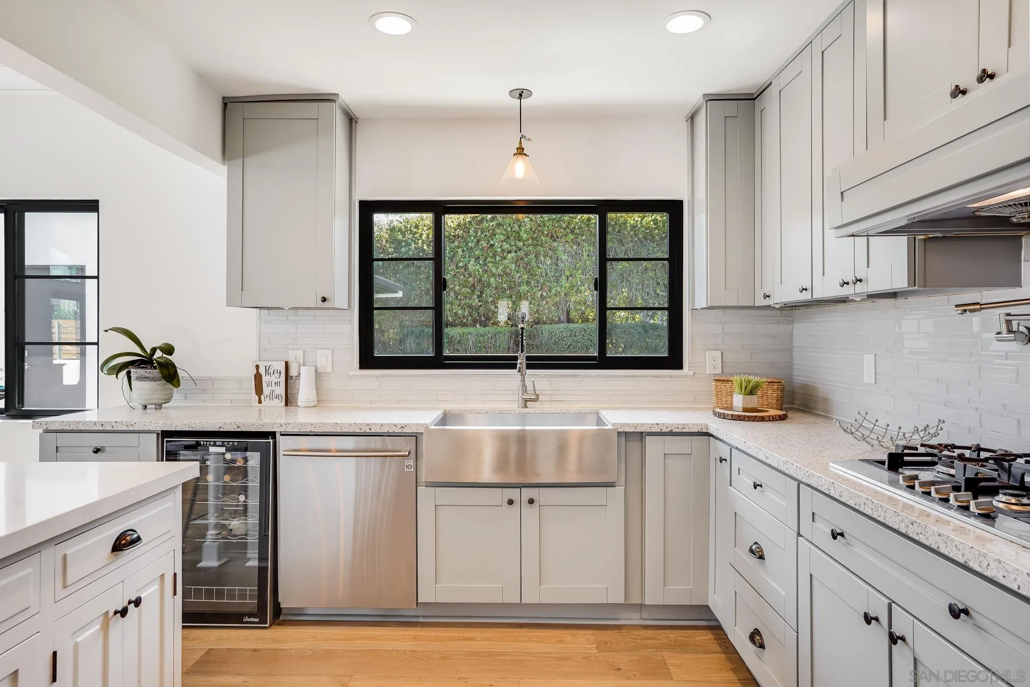8804 Robinhood Lane La Jolla, CA 92037 - Photo 23 of 58 a kitchen with a sink stove and cabinets