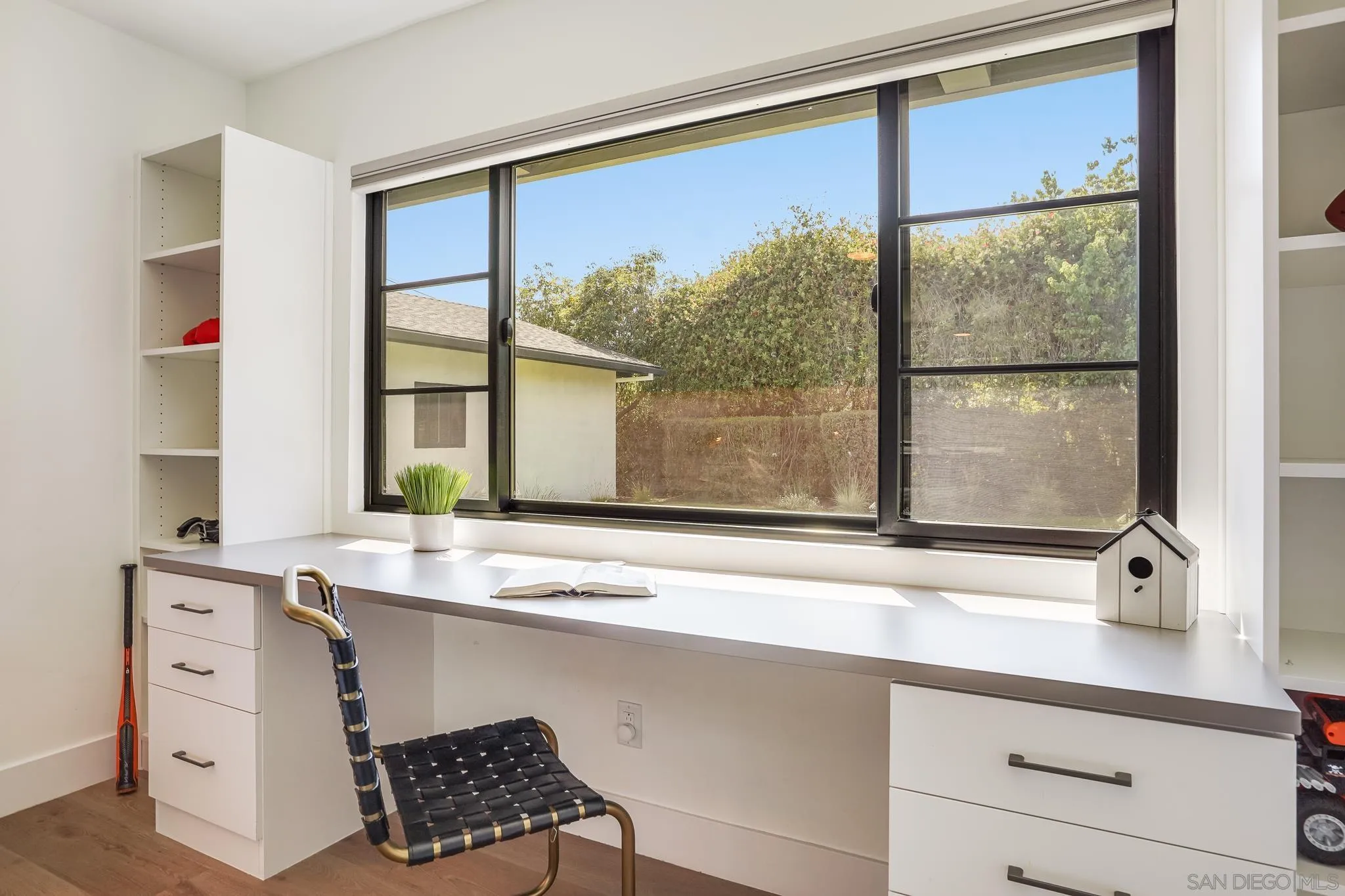 8804 Robinhood Lane La Jolla, CA 92037 - Photo 28 of 58 a bathroom with a sink and a large mirror next to a window