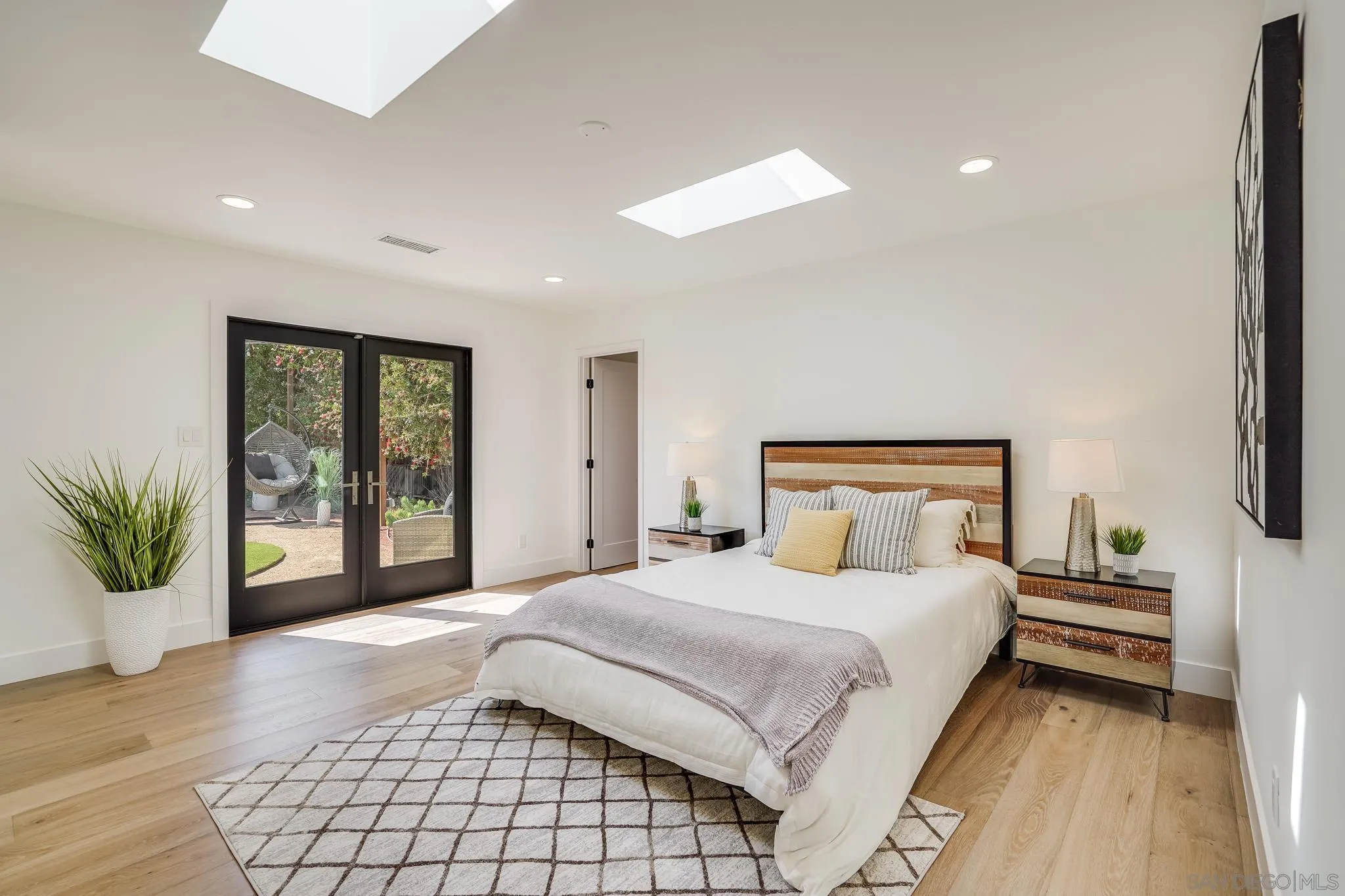 8804 Robinhood Lane La Jolla, CA 92037 - Photo 33 of 58 a bedroom with a large bed and a large window