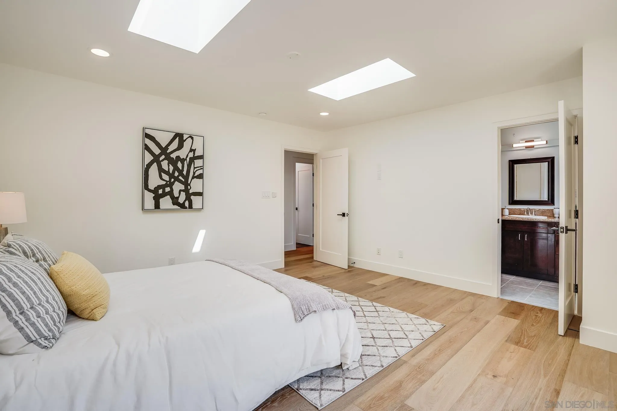 8804 Robinhood Lane La Jolla, CA 92037 - Photo 34 of 58 a bedroom with a large bed and a walk in closet