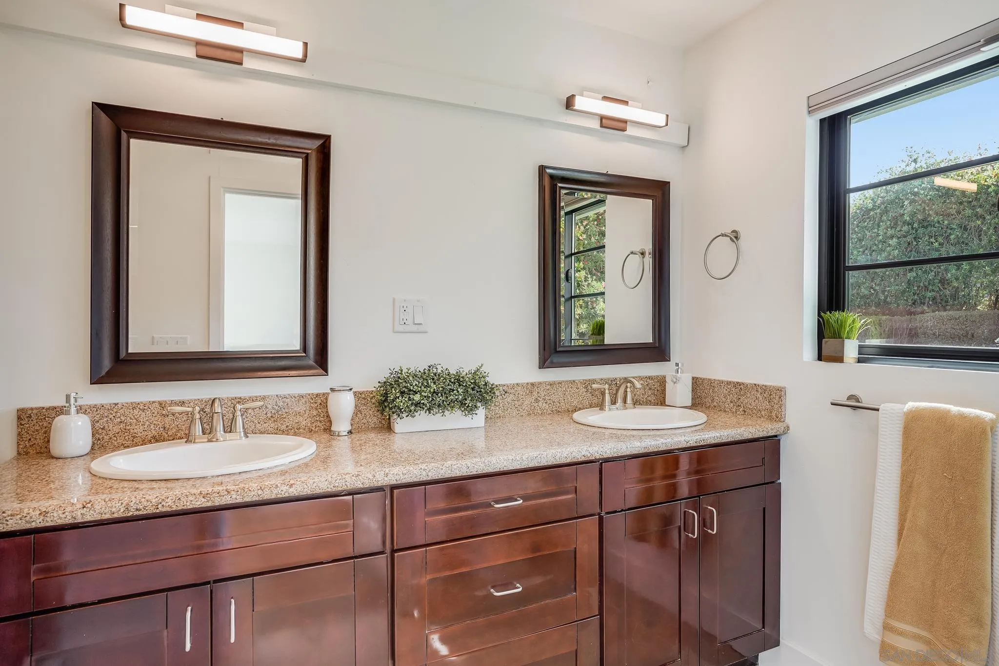 8804 Robinhood Lane La Jolla, CA 92037 - Photo 35 of 58 a bathroom with a granite countertop sink a large mirror and a window