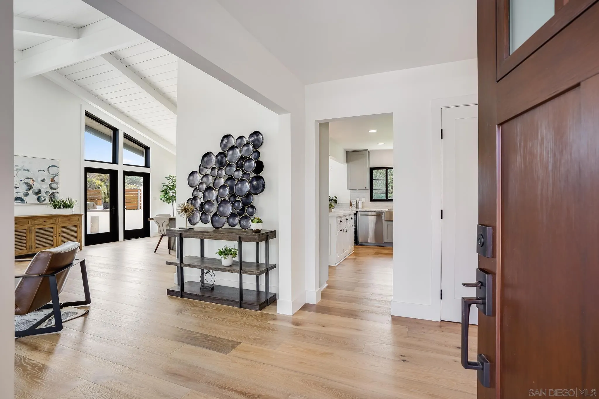 8804 Robinhood Lane La Jolla, CA 92037 - Photo 8 of 58 a view of a livingroom kitchen and dining room with wooden floor