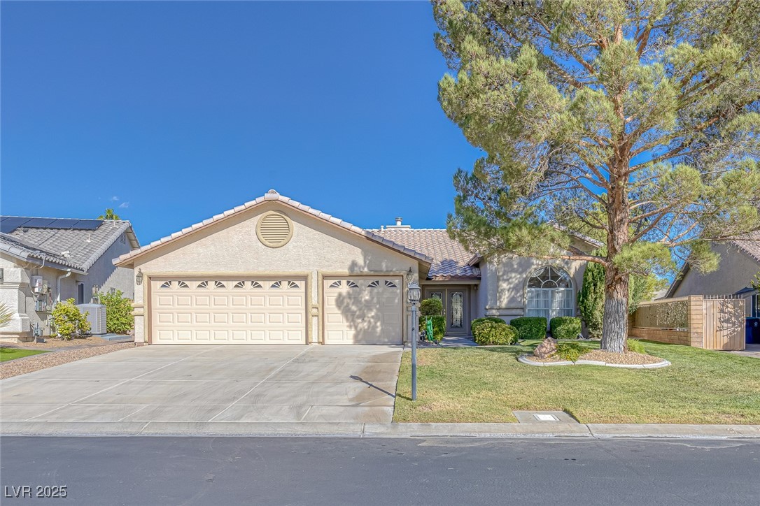 5333 Rim View Lane Las Vegas, NV 89130 - Photo 3 of 55 Ranch-style house featuring a garage, a tiled roof, concrete driveway, and stucco siding