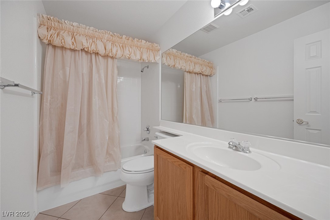 5333 Rim View Lane Las Vegas, NV 89130 - Photo 40 of 55 Bathroom with shower / bath combo, light tile patterned floors, and vanity