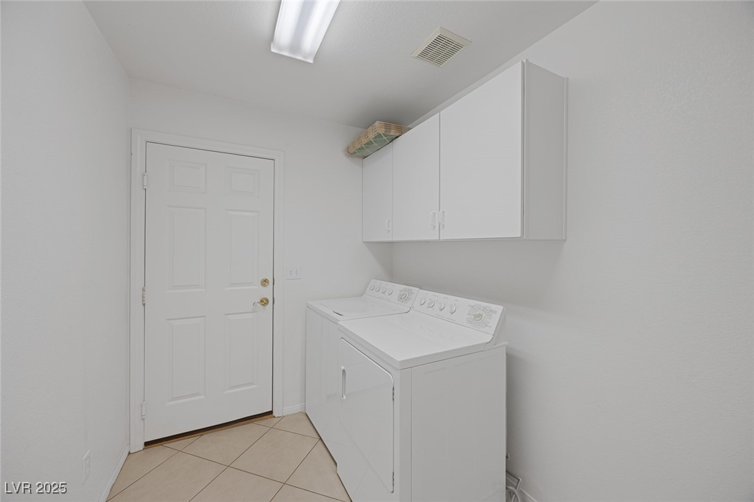 5333 Rim View Lane Las Vegas, NV 89130 - Photo 44 of 55 Washroom featuring light tile patterned floors, independent washer and dryer, and cabinet space