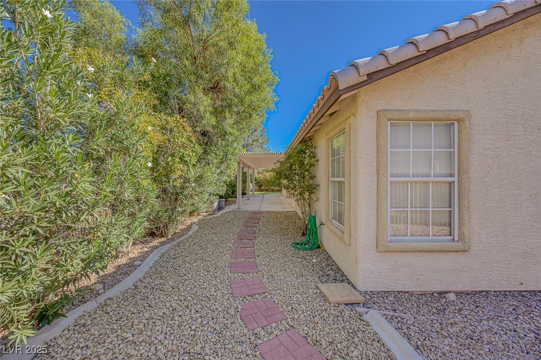 5333 Rim View Lane Las Vegas, NV 89130 - Photo 48 of 55 View of side of property featuring a tiled roof and stucco siding