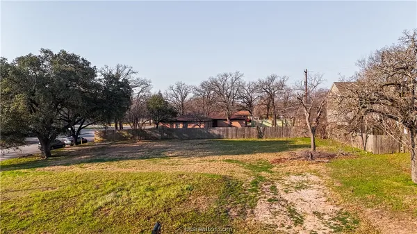 a view of a yard with swimming pool and trees