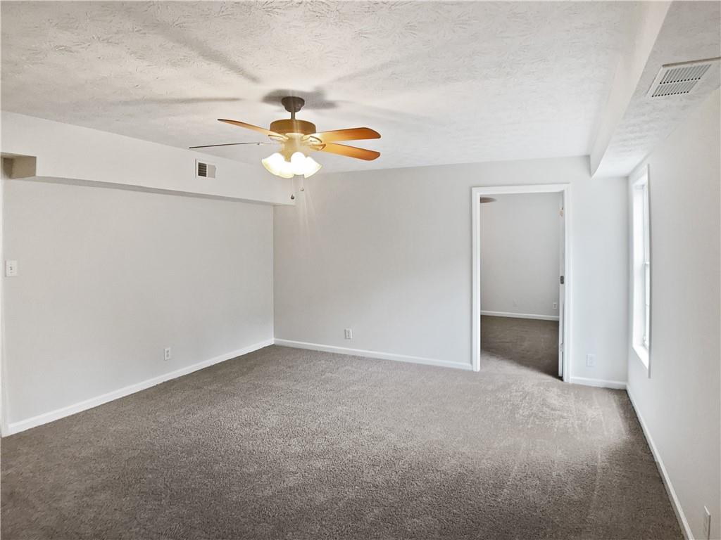 1780 North Round Road Lawrenceville, GA 30045 - Photo 13 of 24 an empty room with windows and fan
