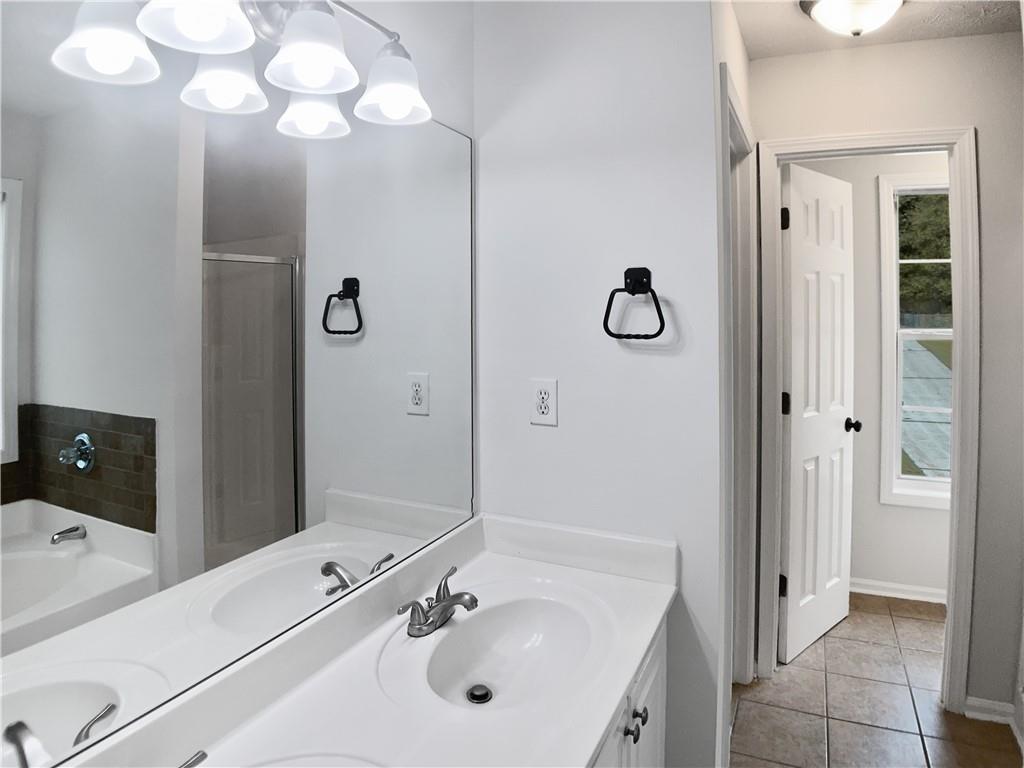 1780 North Round Road Lawrenceville, GA 30045 - Photo 14 of 24 a bathroom with a tub sink and mirror