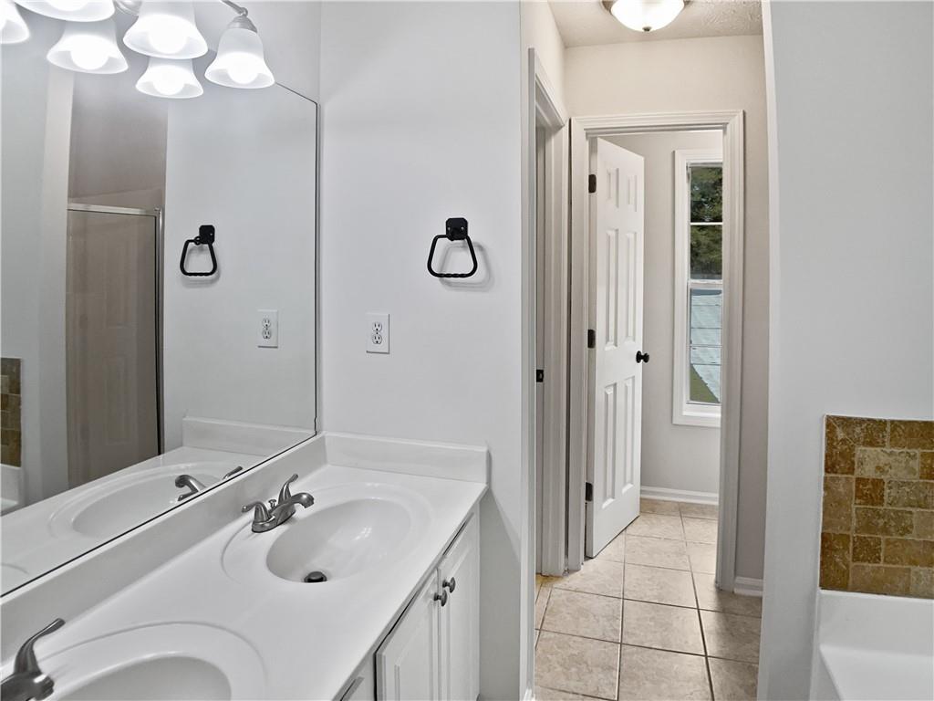 1780 North Round Road Lawrenceville, GA 30045 - Photo 17 of 24 a bathroom with a sink vanity granite tub shower and mirror