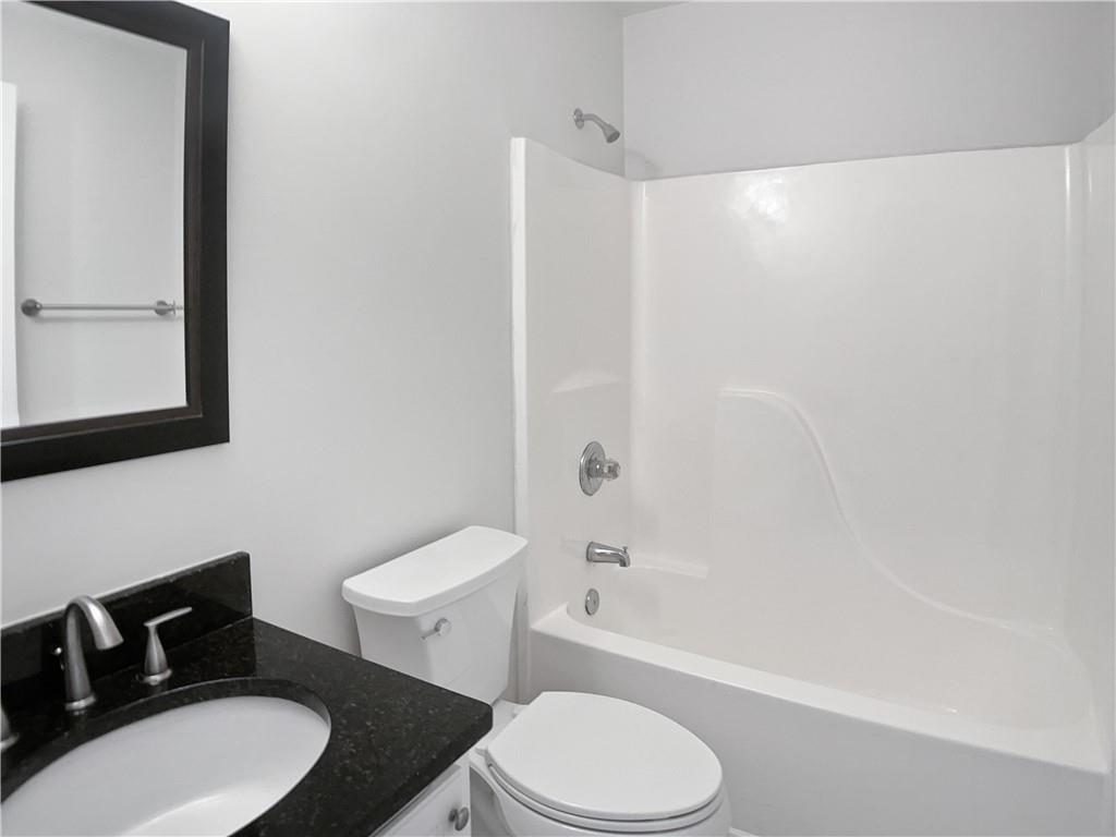 1780 North Round Road Lawrenceville, GA 30045 - Photo 19 of 24 a bathroom with a toilet a sink and a bathtub