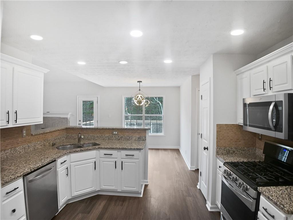1780 North Round Road Lawrenceville, GA 30045 - Photo 6 of 24 a kitchen with granite countertop a stove and a sink