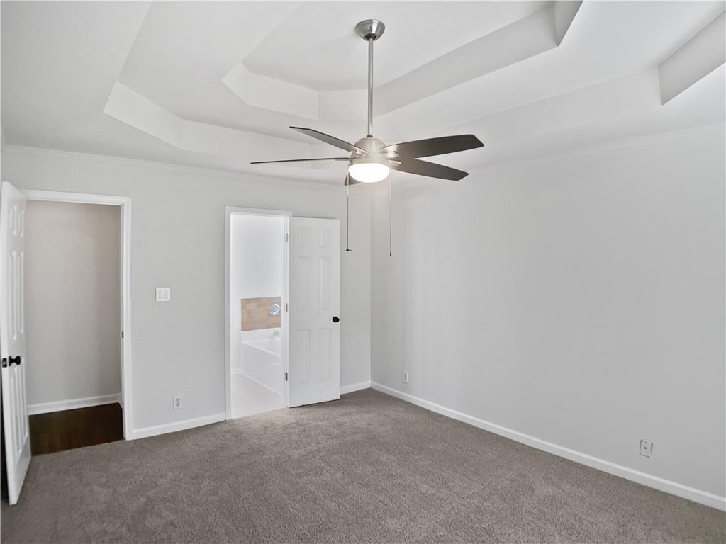 1780 North Round Road Lawrenceville, GA 30045 - Photo 8 of 24 an empty room with a fan and a ceiling fan