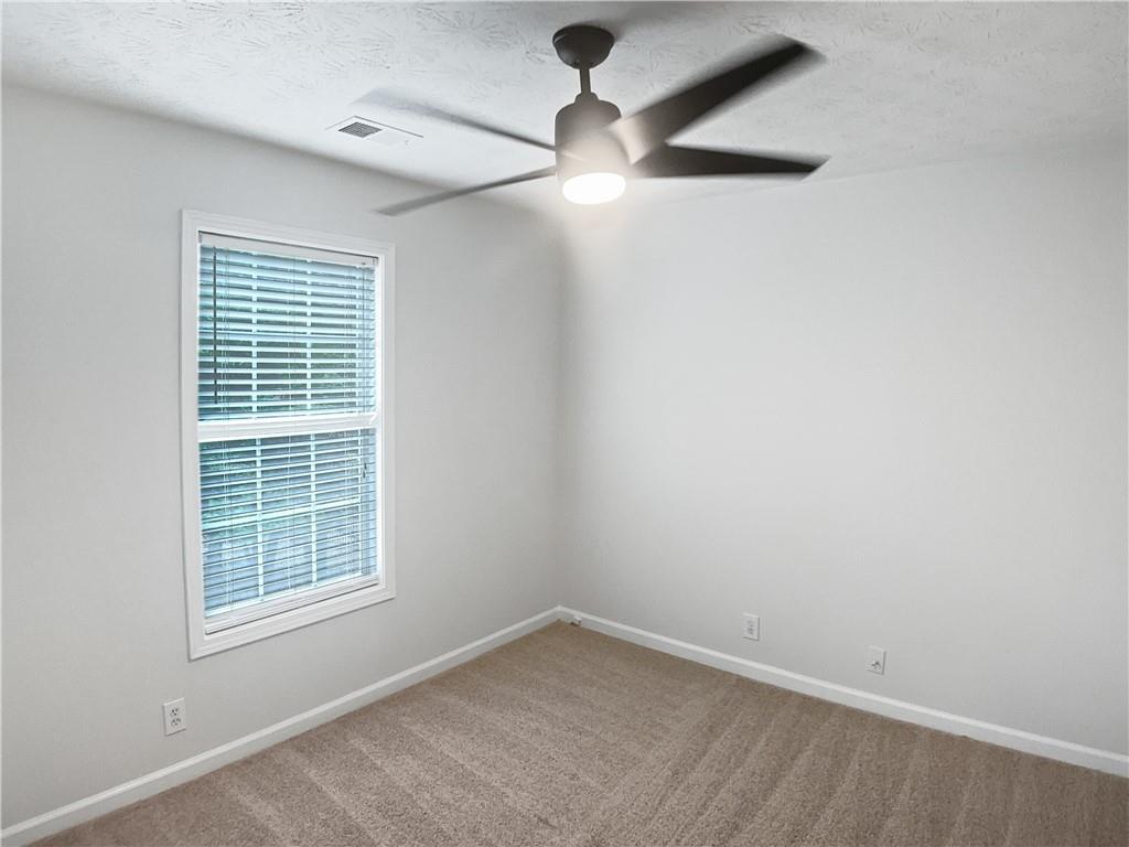 1780 North Round Road Lawrenceville, GA 30045 - Photo 10 of 24 an empty room with a window and a fan