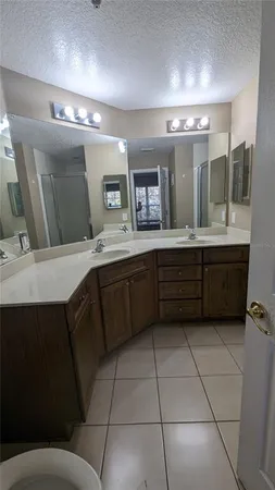 a kitchen with a sink a counter space and cabinets