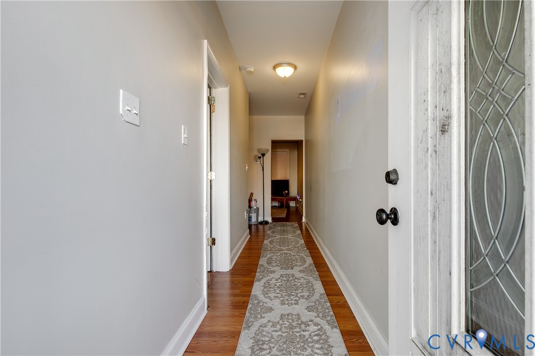 1237 West Cary Street Richmond, VA 23220 - Photo 3 of 23 a view of a hallway with wooden floor and a bathroom