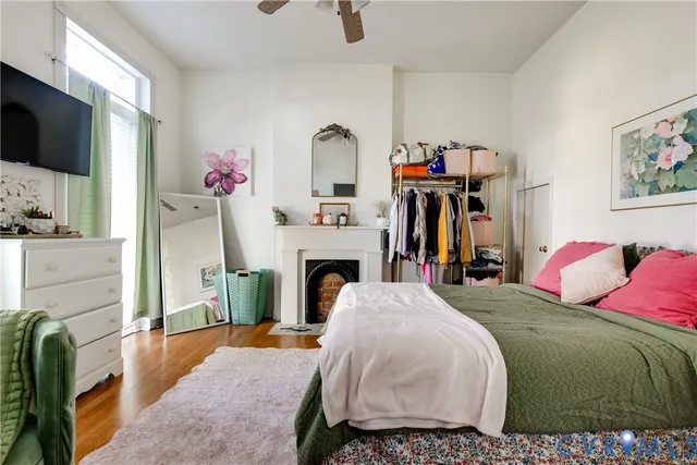 a spacious bedroom with a bed and a flat screen tv