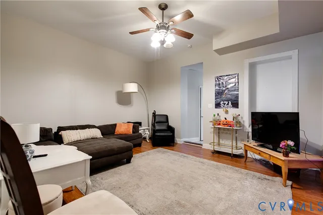 a living room with furniture and a flat screen tv