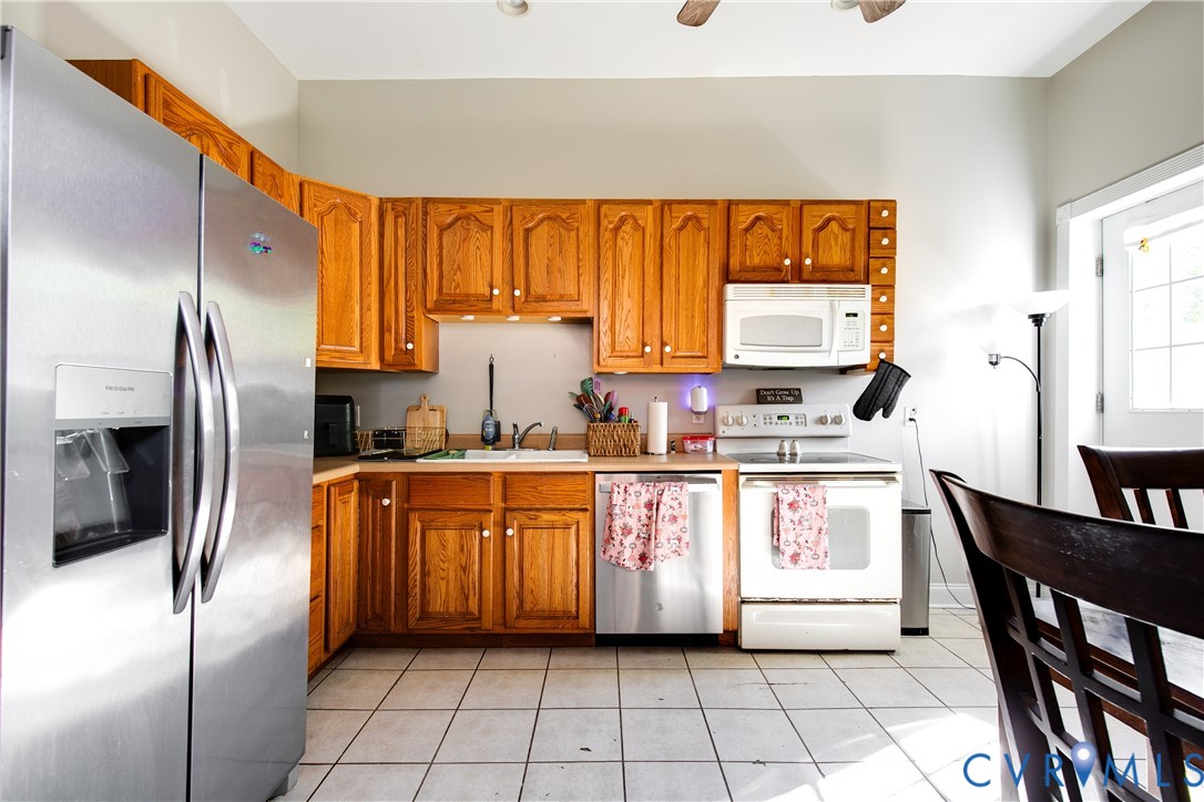 1237 West Cary Street Richmond, VA 23220 - Photo 8 of 23 a kitchen with stainless steel appliances a refrigerator sink and cabinets