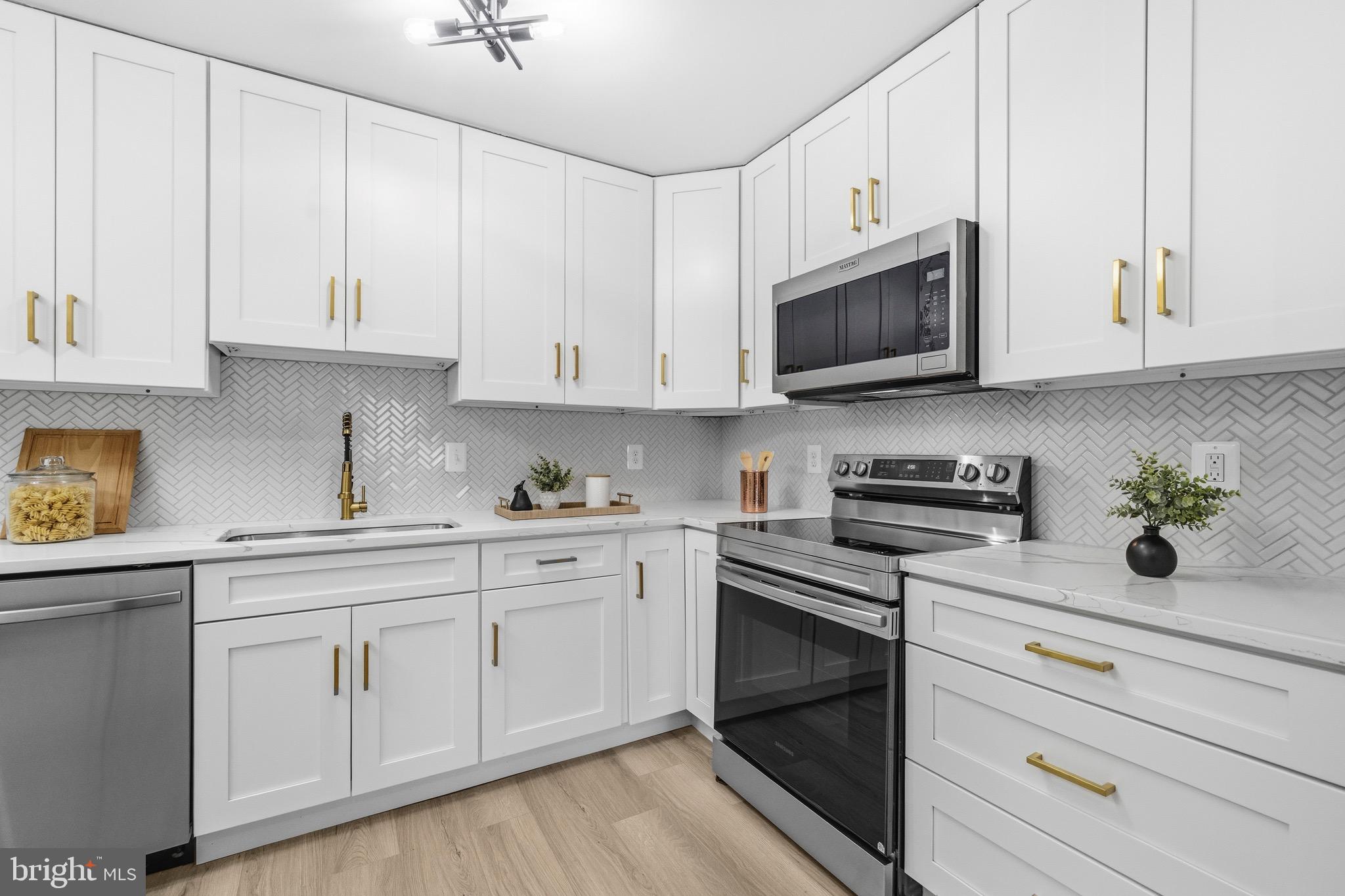 6101 Edsall Road, Unit 602 Alexandria, VA 22304 - Photo 4 of 38 a kitchen with white cabinets and white appliances