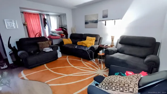 a view of a balcony with furniture and floor to ceiling window