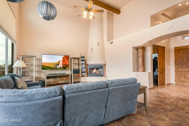 a living room with furniture fireplace and flat screen tv