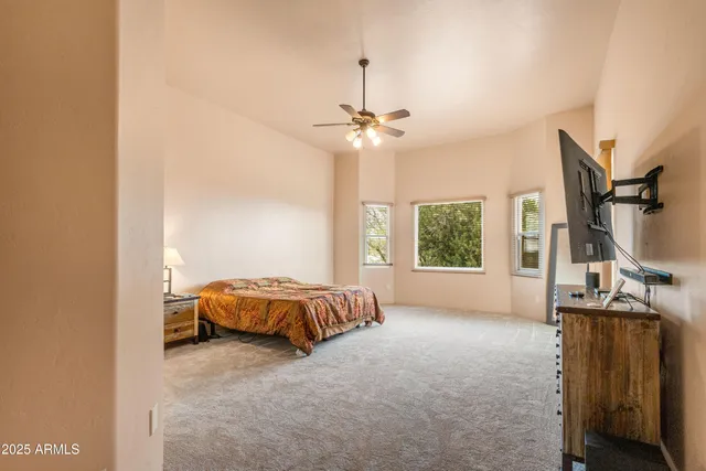 a spacious bathroom with a double vanity sink a mirror and a shower
