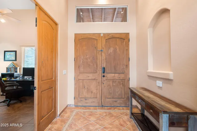 a view of a workspace with furniture and a window