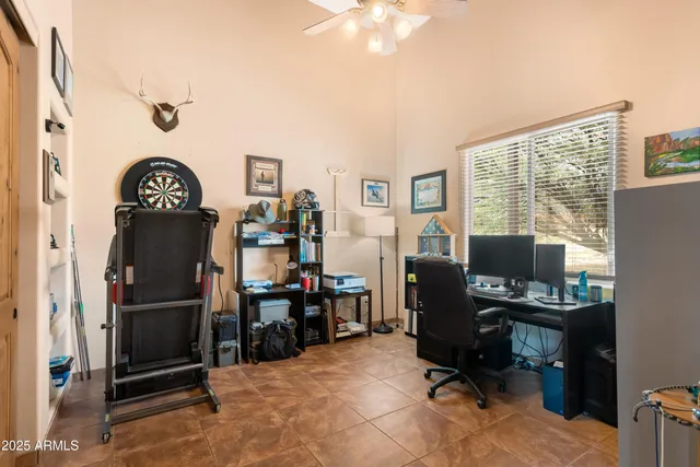 a living room with furniture a fireplace and a large window