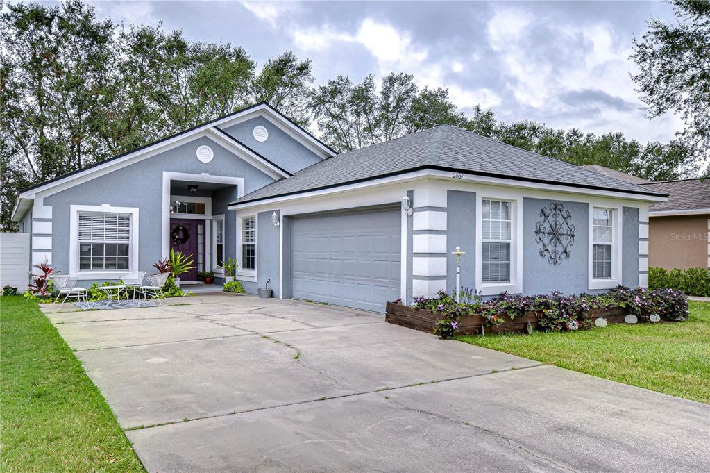 6867 Shadow Cast Lane Lakeland, FL 33813 - Photo 1 of 1 a front view of a house with garden