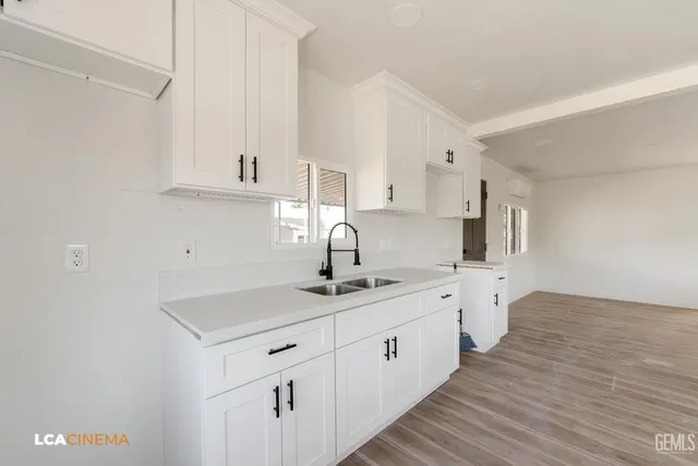 a kitchen with a sink and cabinets