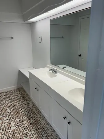 a bathroom with a sink a vanity and a mirror